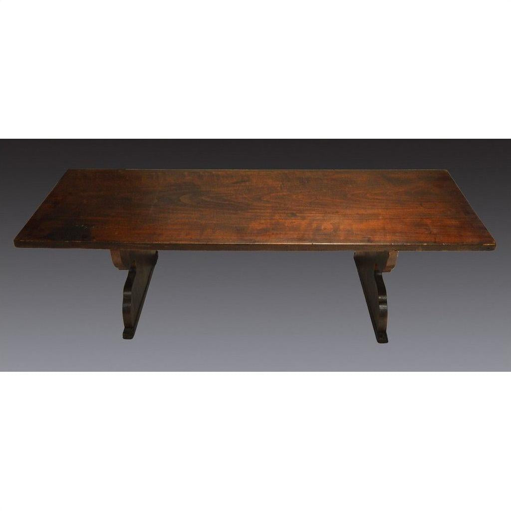 Dark wood antique Japanese desk with rectangular top and two curved, sturdy legs on each side.