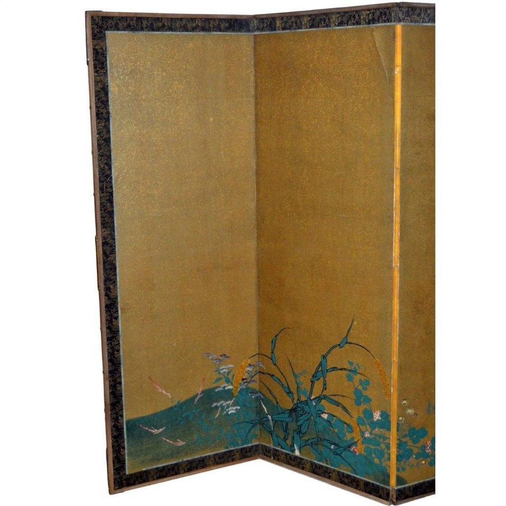 Gold gilt Japanese screen with six Taisho panels, floral and green foliage motifs, dark patterned border, front view.