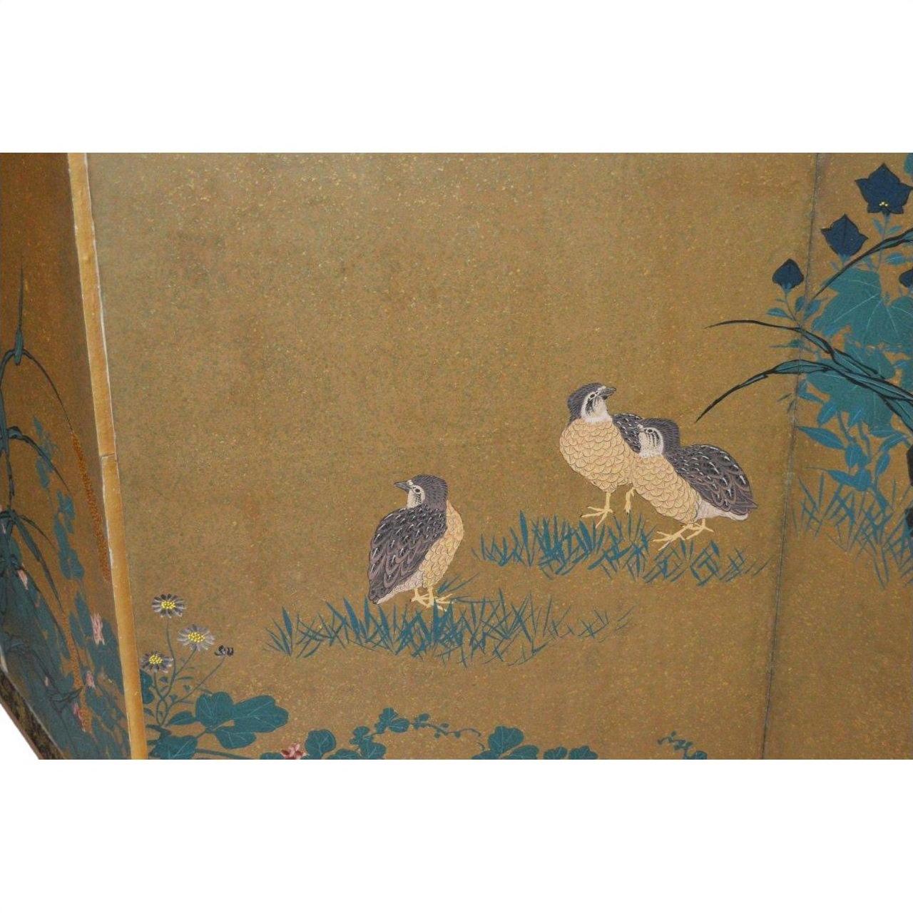 Antique Japanese gilt screen with three brown quails on green grass near plants, detailed scene.