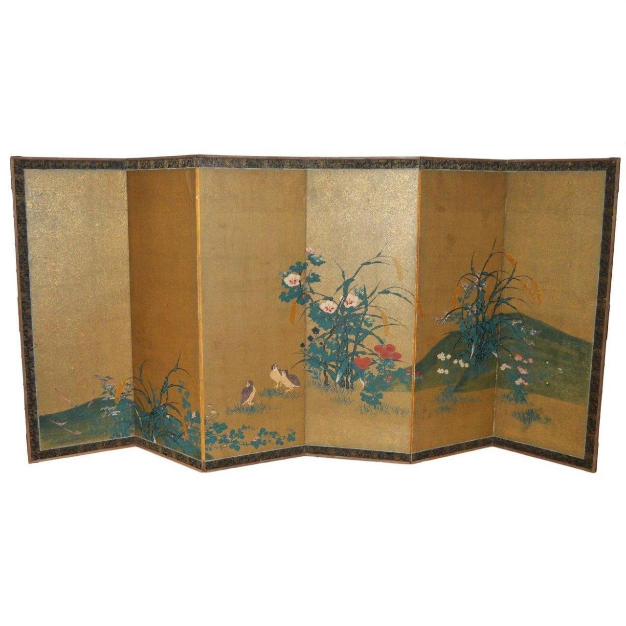 Gold gilt Japanese screen with painted birds, flowers, and greenery on rice paper framed by a decorative border.
