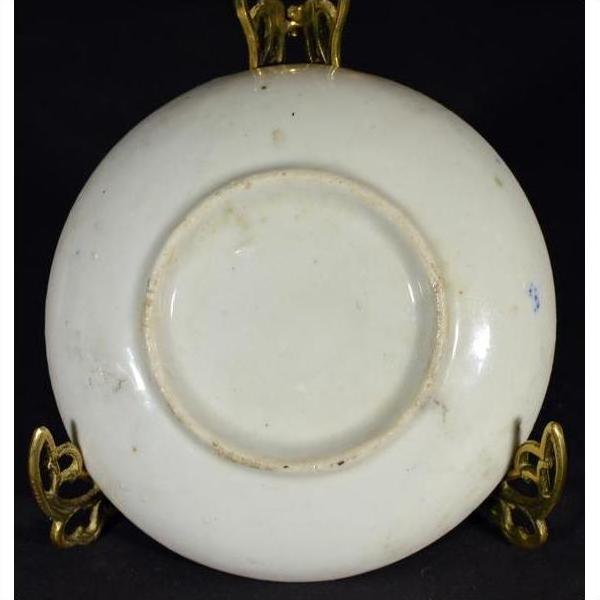 White porcelain Japanese Igezara transferware plate on decorative gold stand.