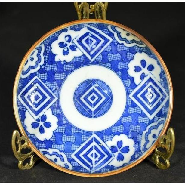Blue and white ceramic Japanese Igezara transferware plate on brass stand.