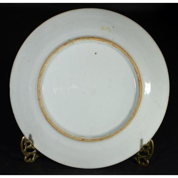 White and blue ceramic Japanese Igezara transferware plate with slightly worn base on a metal stand.