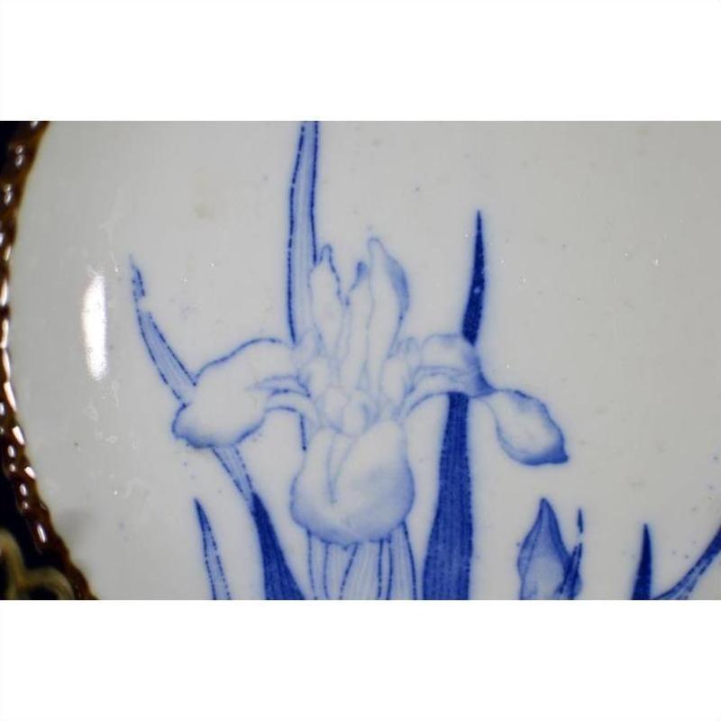 Blue and white porcelain Igezara plate with iris design, antique Japanese transferware, close-up view.