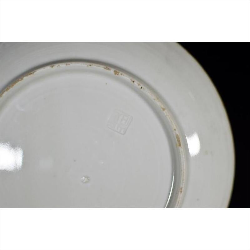 Close-up of the underside of an antique Japanese Igezara ceramic plate showing a square embossed maker’s mark near center.