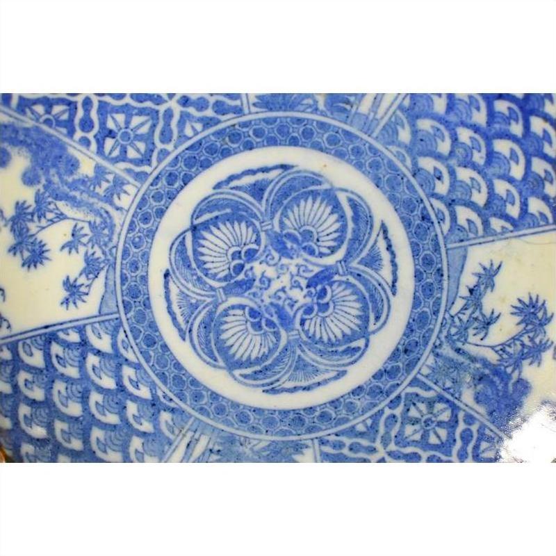 Blue and white ceramic Igezara transferware plate with intricate floral and geometric designs, close-up.