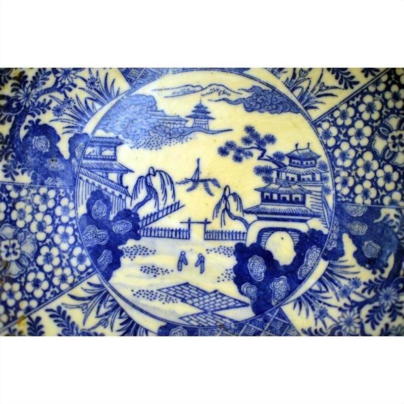 Blue and white porcelain Igezara plate with transferware landscape, trees, buildings, and figures.
