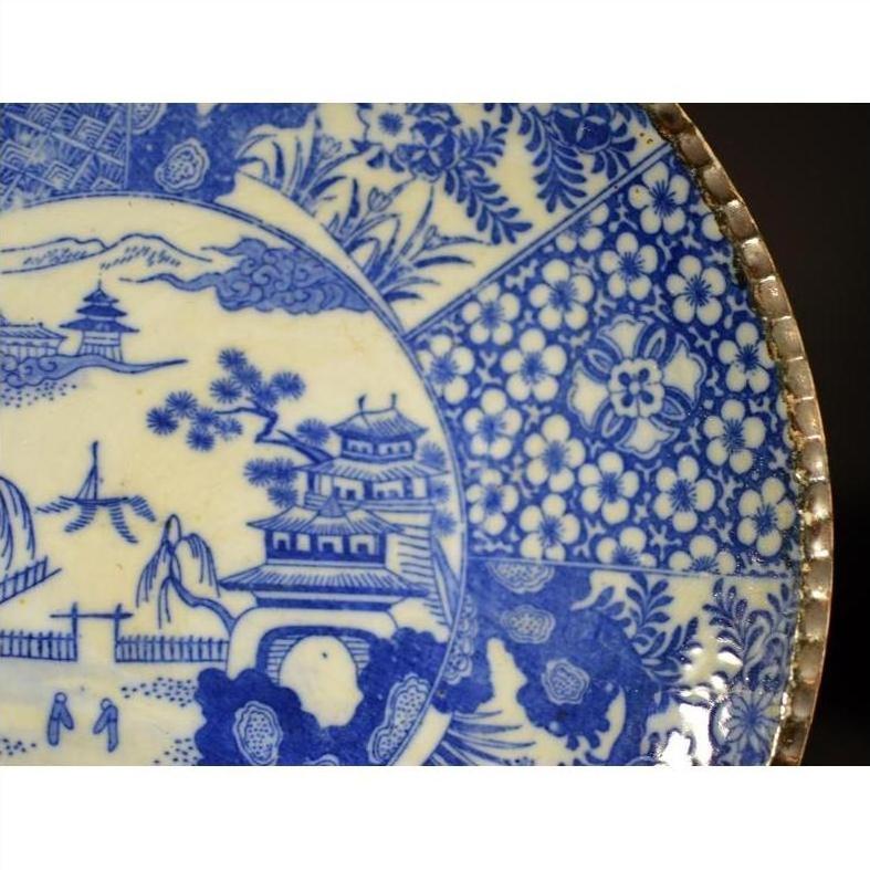 Close-up of blue and white porcelain Igezara Japanese transferware plate with intricate patterns.