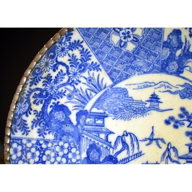 Close-up of blue and white porcelain Igezara plate with antique floral designs, Japanese transferware style.