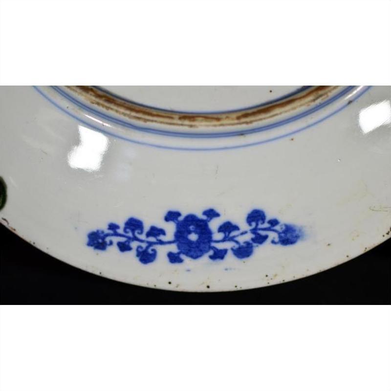 Blue and brown porcelain plate with vine pattern by rim and central ring, antique Japanese transferware.