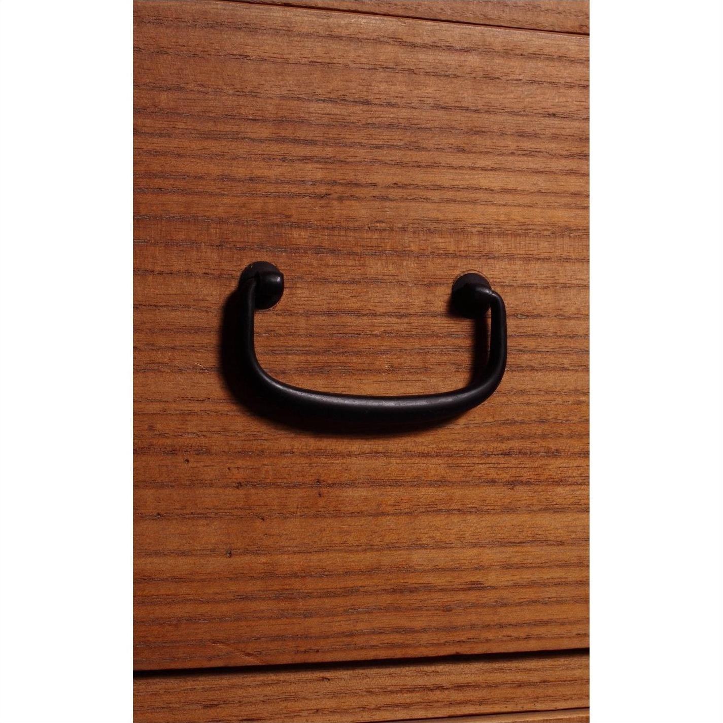 Close-up of black metal handle on antique Japanese Kiri wood chest with horizontal grain and modern design.