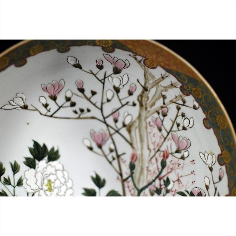 Close-up of antique Japanese Kutani porcelain bowl with hand painted pink blossoms and floral accents.