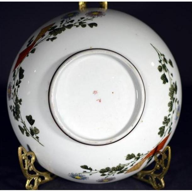 Close-up of the underside of an antique Japanese Kutani hand-painted porcelain bowl on a decorative gold stand.
