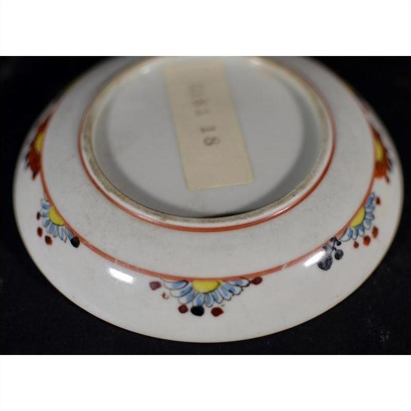 Close-up of the bottom of an antique Japanese Satsuma porcelain plate with a rectangular center label.