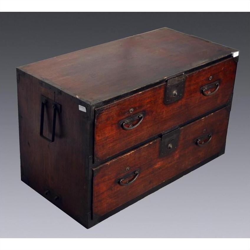 Brown wooden Japanese Tansu with two large drawers, metal handles, and corner reinforcements on gray background.