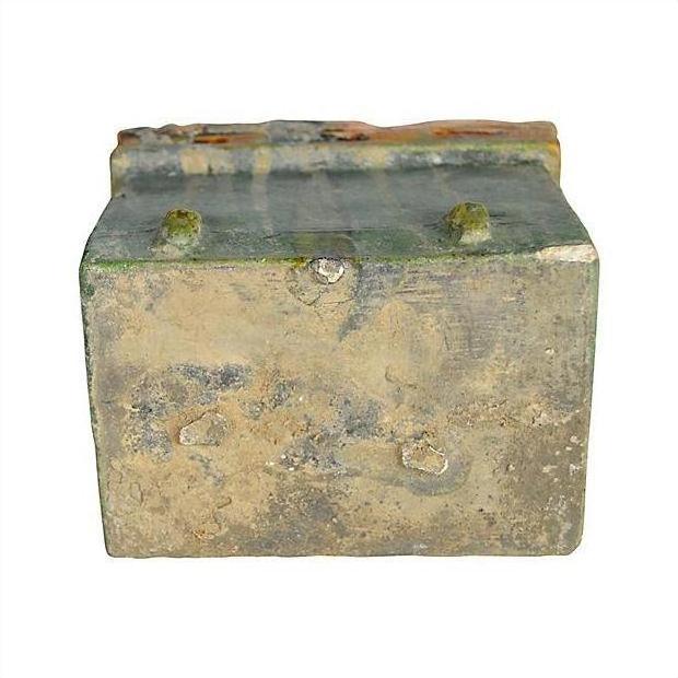 Weathered brown wood miniature Chinese treasure chest with four small top protrusions, close-up view.