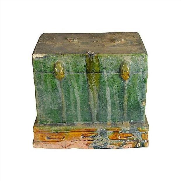 Close-up of rectangular green-glazed ceramic miniature Chinese treasure chest with brownish-orange accents.