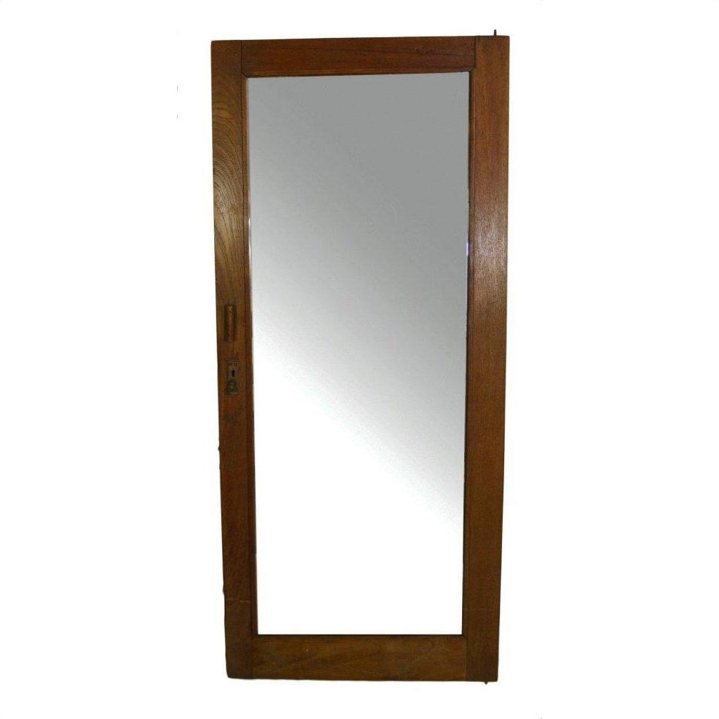 Close-up of antique mirror with rectangular wooden frame and metal latch on one side.