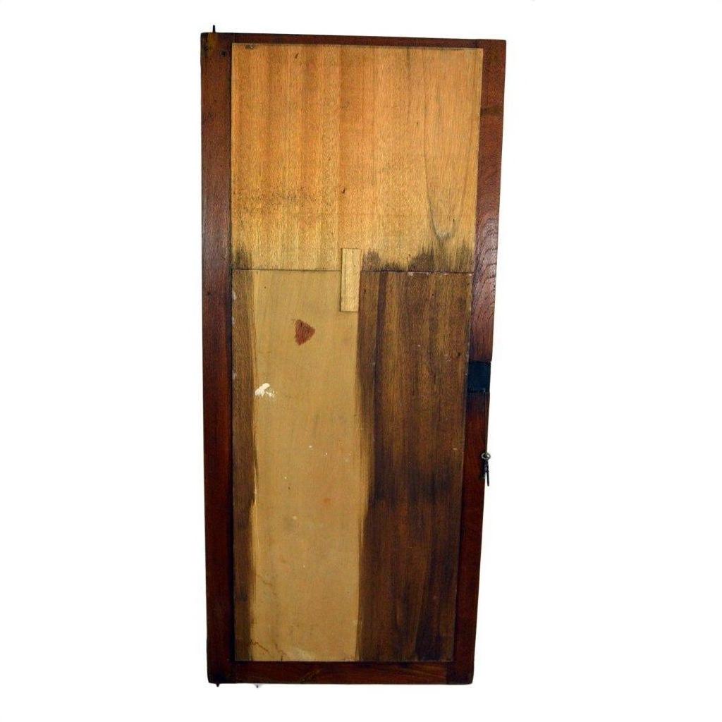 Antique mirror with multi-shade panels, visible wood grain, and a sturdy metal lock on right side, close-up view.