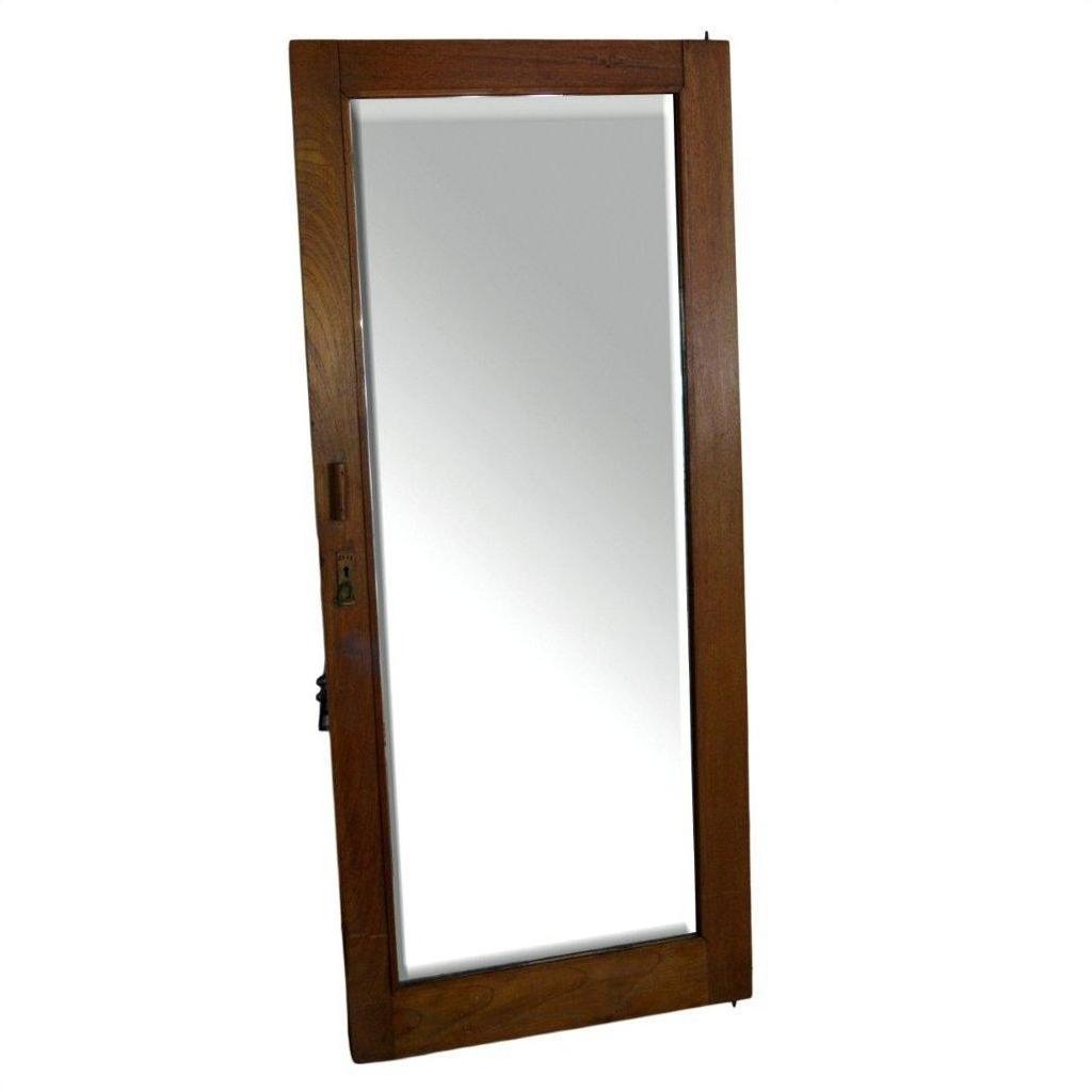 Antique mirror with angled reflection in sunlight, visible upright, showing detailed frame and glass surface.