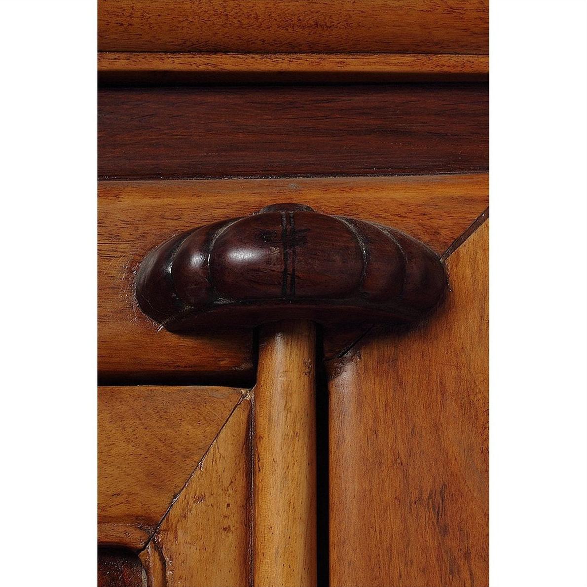 Close-up of carved wooden handle on antique brown elm and cypress cabinet, 19th-century Ningbo, China.