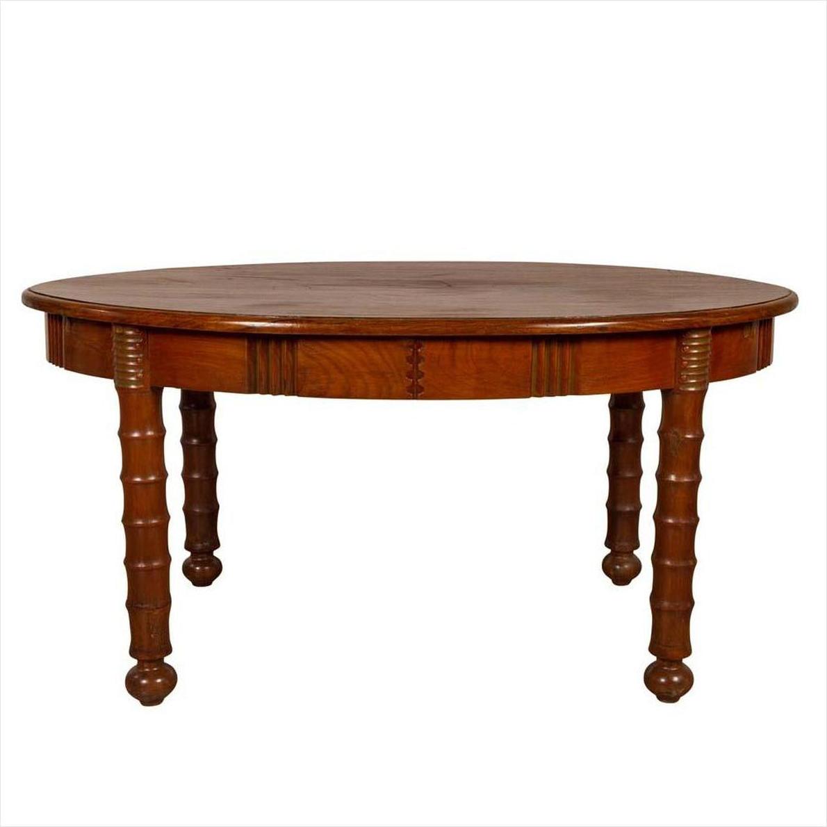 Brown wood antique oval dining table with spindle legs and warm patina, shown against a plain white background.