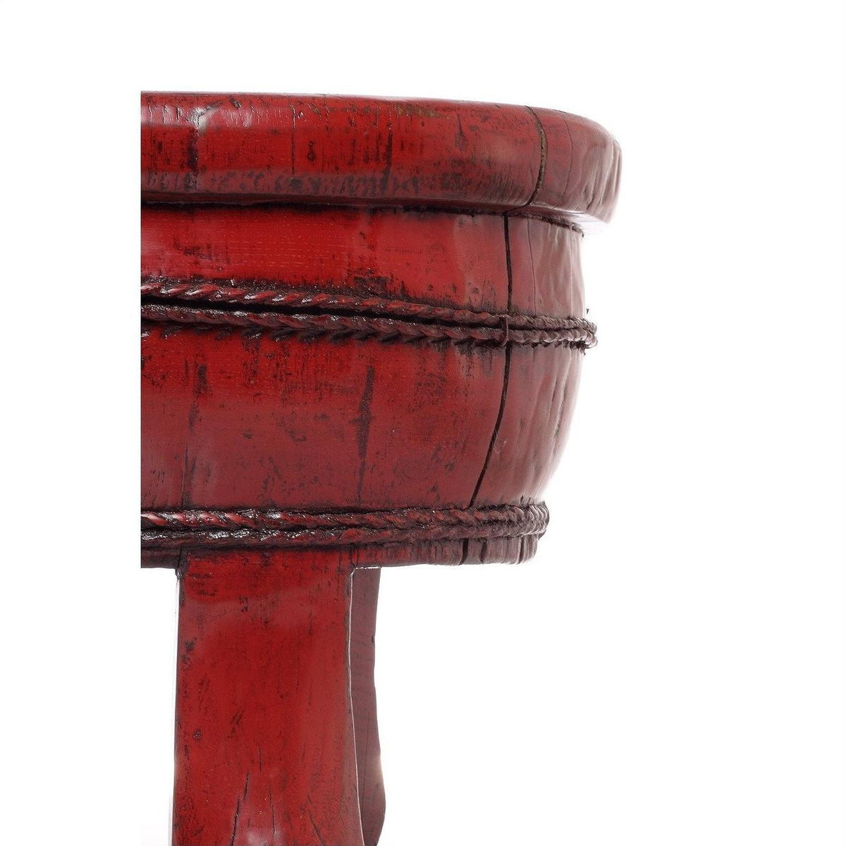 Close-up of antique red wooden basin with carved textured details, set against a plain white background.
