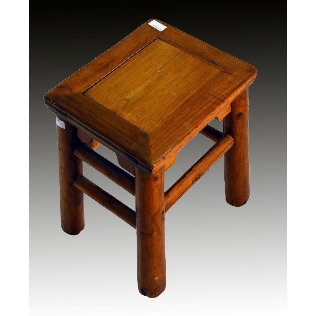 Close-up of a small, square rustic Chinese elm stool with thick legs on a gradient background.
