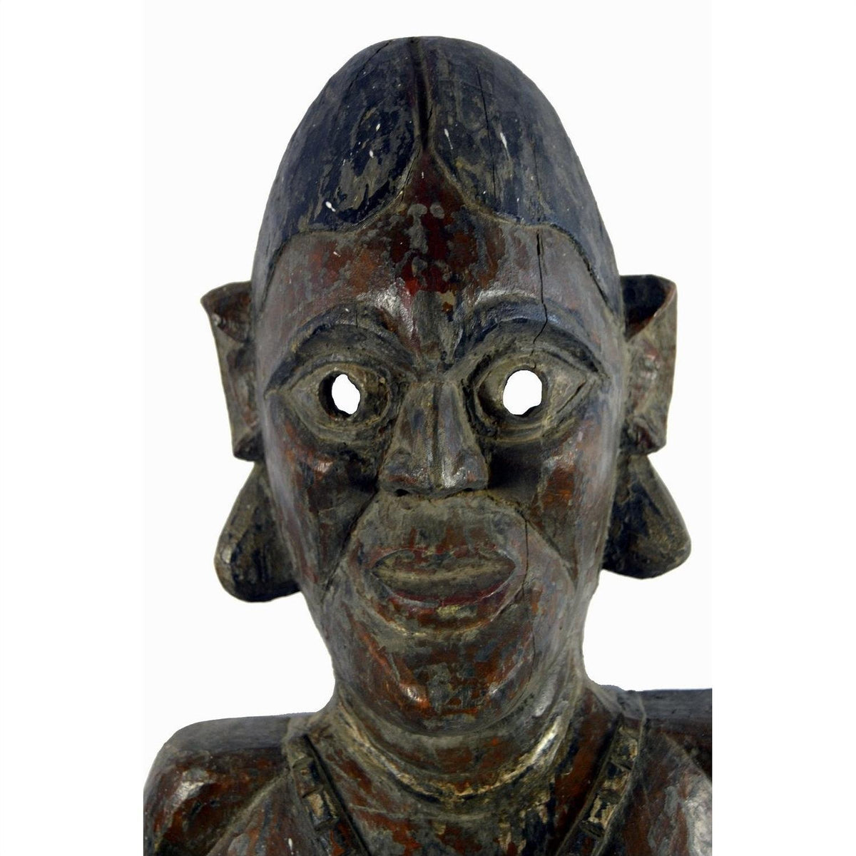 Brown wooden Sumatra fertility mask with large eyes, prominent ears, and carved details on a white background.