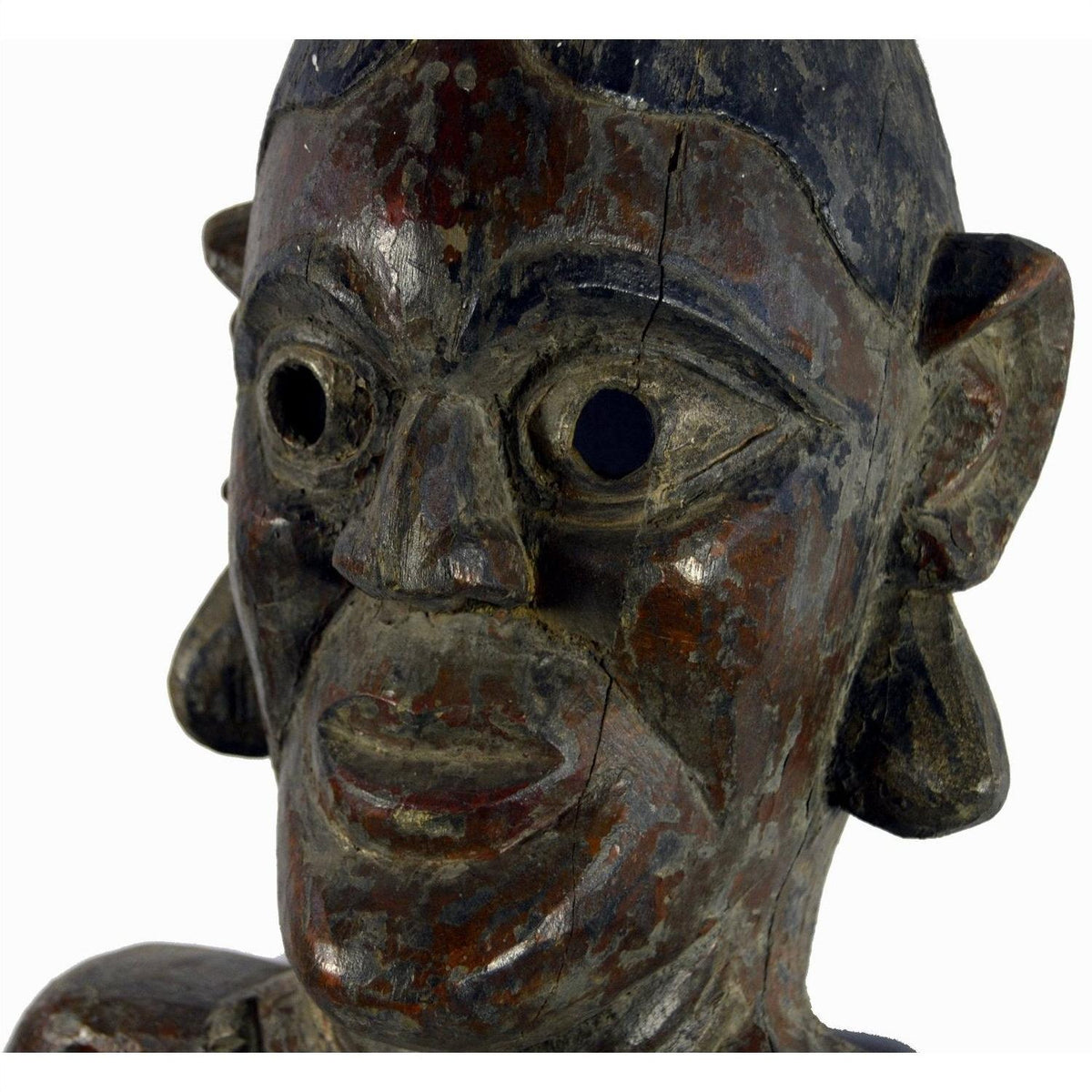 Close-up of weathered wooden Sumatra fertility mask with hollow eyes and large ears, 25 inches tall.