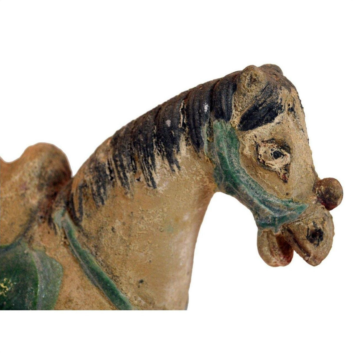 Close-up of a glazed terracotta Ming Dynasty horse with faded paint and green harness.