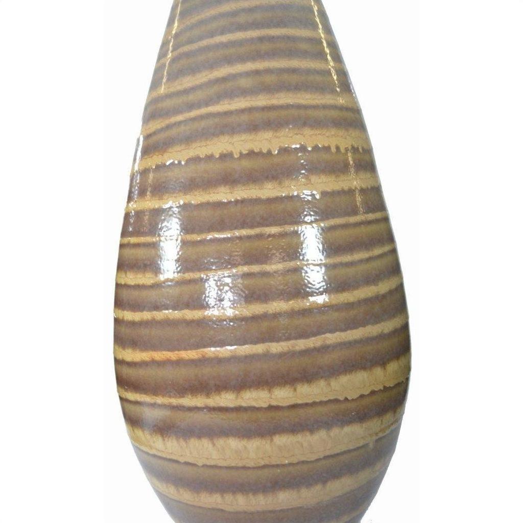 Close-up of large ceramic vase in glossy earth tones with brown and tan horizontal stripes, wood grain look.
