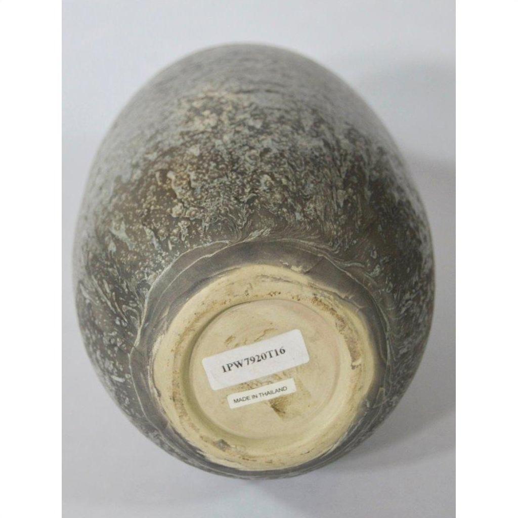 Close-up bottom view of brown ceramic Artisan vase with two labels, one reading "MADE IN THAILAND.