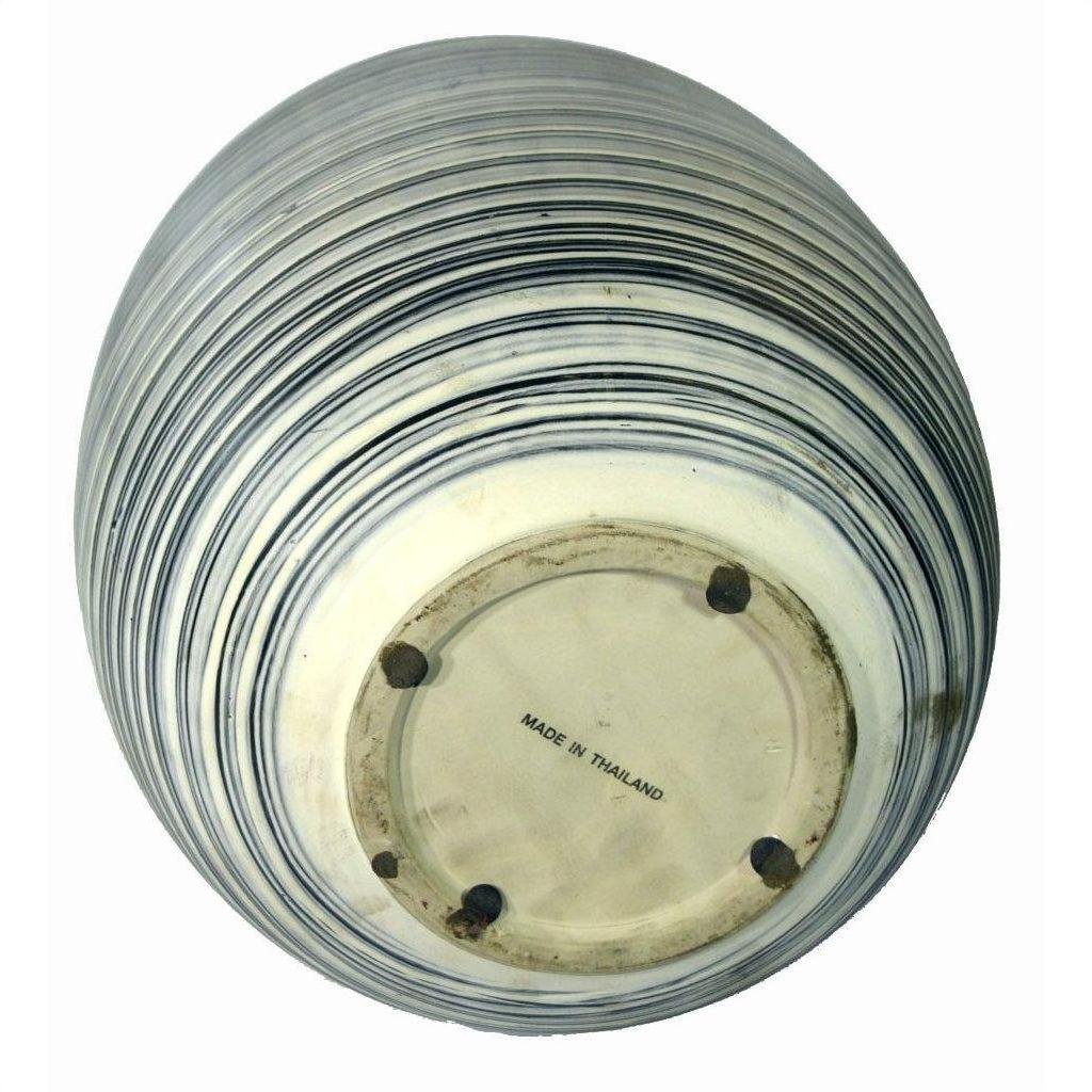 Close-up bottom view of a blue-striped ceramic vase with "MADE IN THAILAND" on the base.