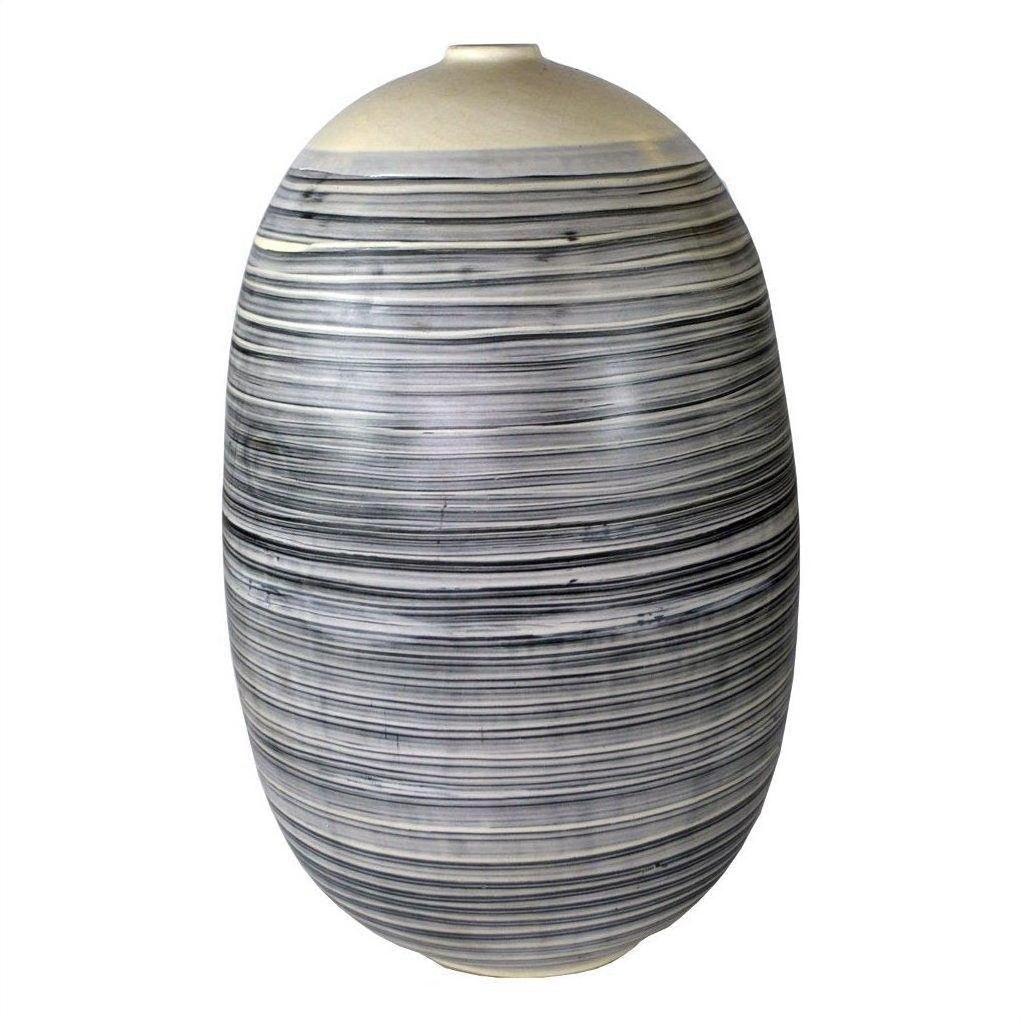 White ceramic vase with thin black stripes, rounded shape, close-up view.