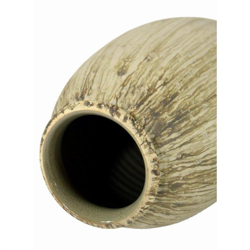 Close-up of unglazed beige ceramic vase with brown textured streaks, showing rim and opening.