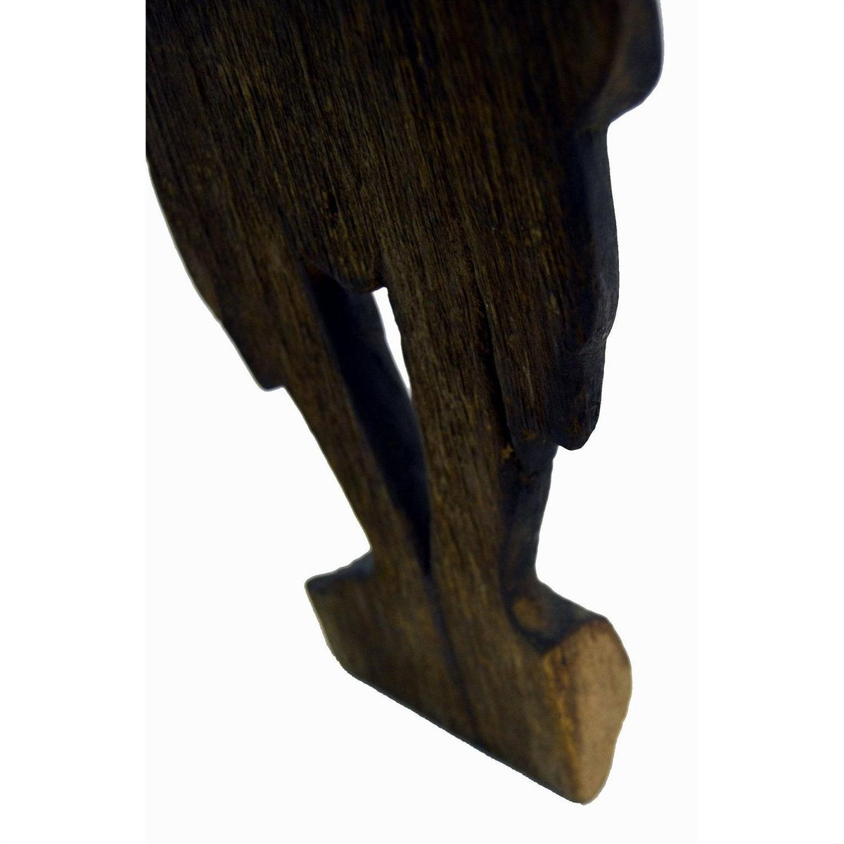Close-up of a brown wood Balinese hand carved temple dancer silhouette, angled on white background.
