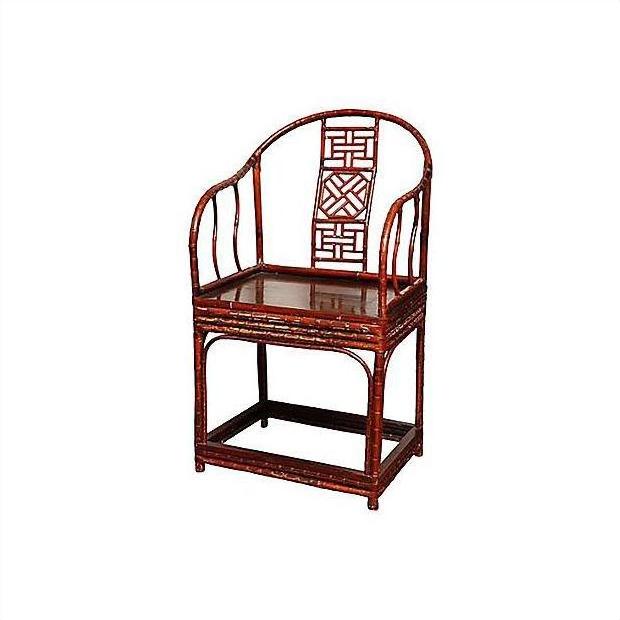 Brown bamboo horseshoe chair with curved back, lattice design, and straight legs against white background.