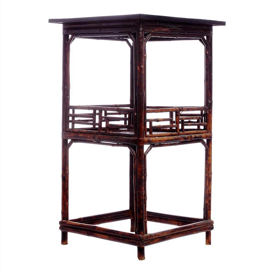 Brown bamboo-style tall lamp table with square top and decorative railings, open frame, close-up view.
