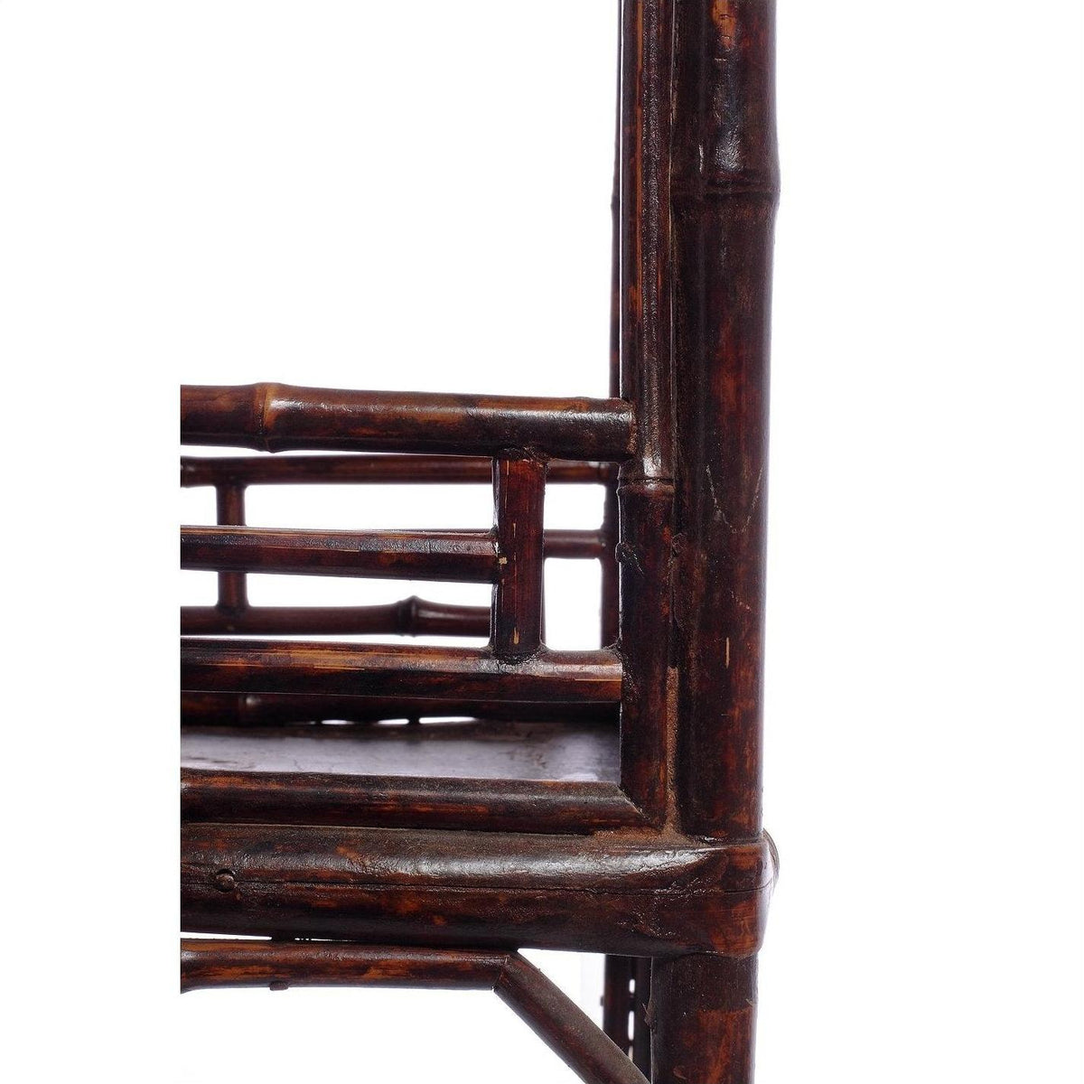 Close-up of lacquered bamboo-style lamp table with geometric design, shown against a white background.