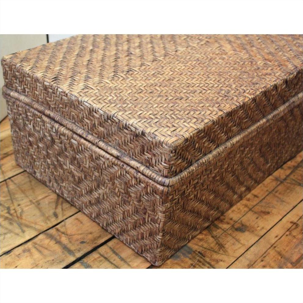Rectangular bamboo trunk with lid on a wooden floor, natural finish, home storage furniture.