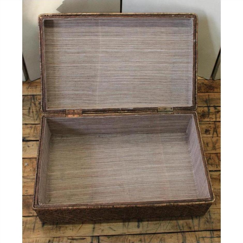 Natural bamboo trunk with lid open, interior visible, placed on a wooden floor.