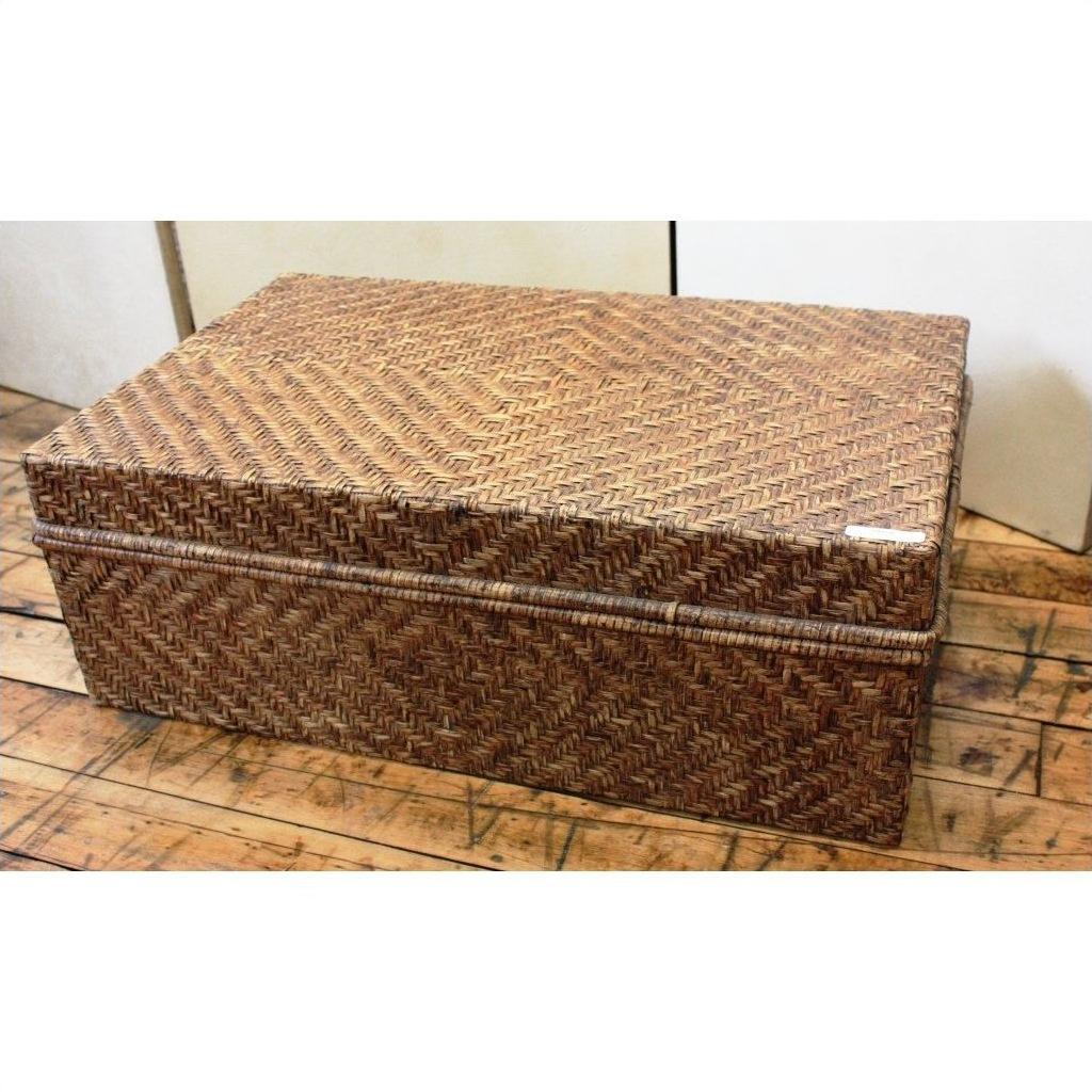Large bamboo trunk on wooden floor against plain wall, natural finish, product displayed in simple indoor setting.