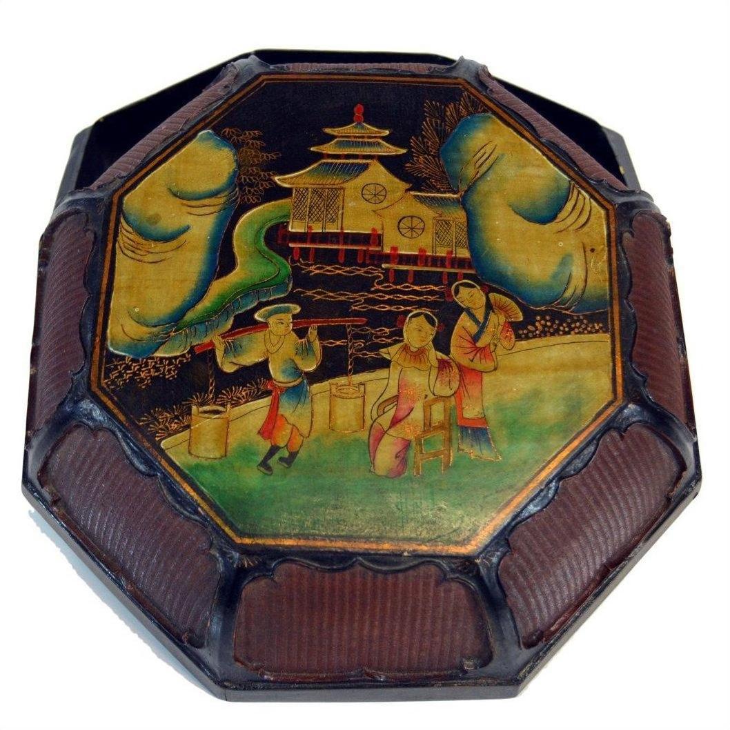 Black lacquer octagonal tray with basket-like edges, Asian figures, trees, and pagoda decoration.