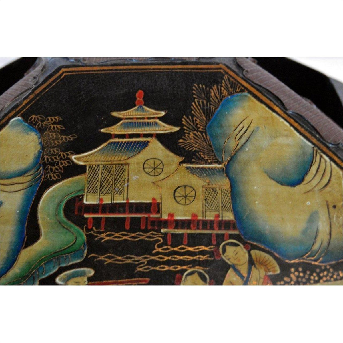 Close-up of black lacquer painting with Asian-style pagoda, trees, people, and basket with top detail.