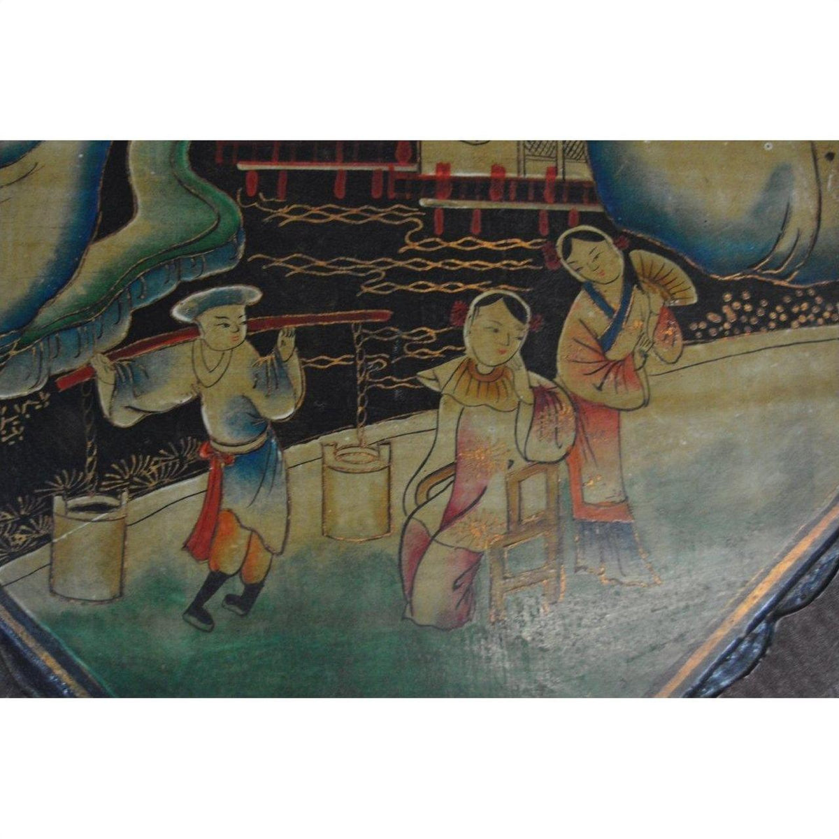 Brown woven basket with lid, three people in traditional attire outdoors against a painted background.