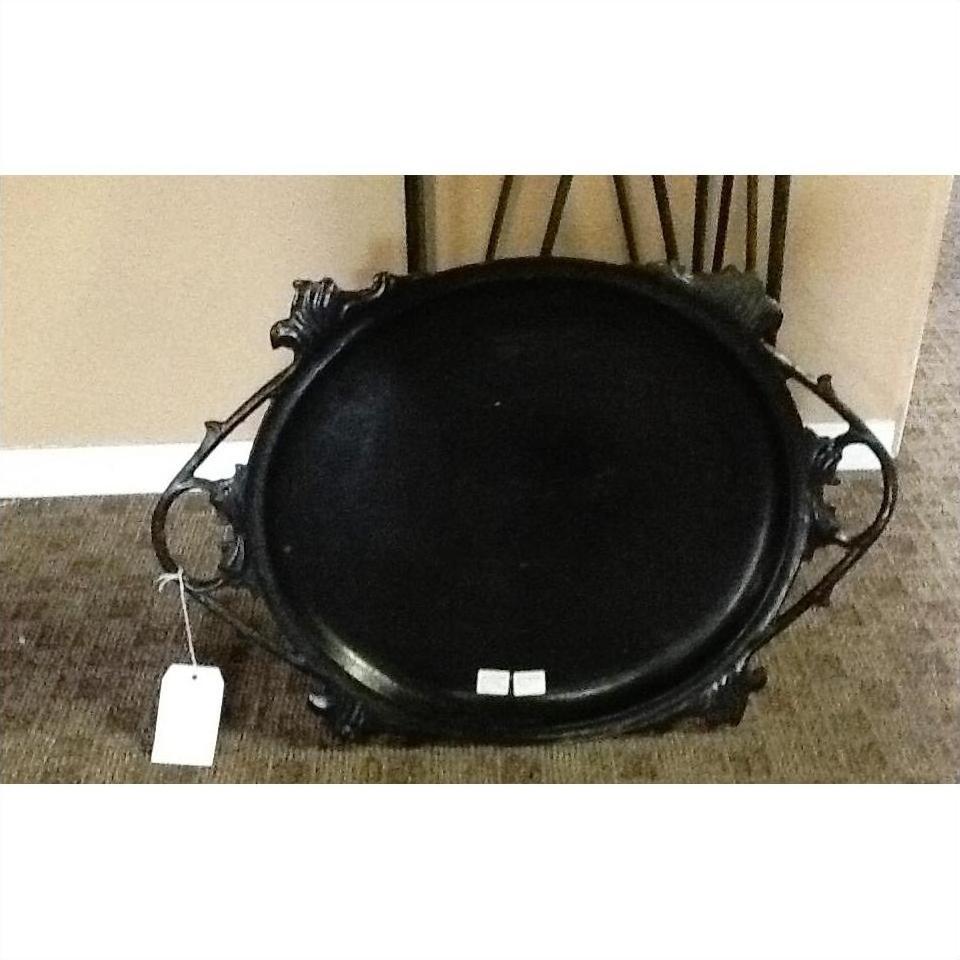 Black lacquer tray with open handles on brown carpet, sale tag attached, positioned against a wall.