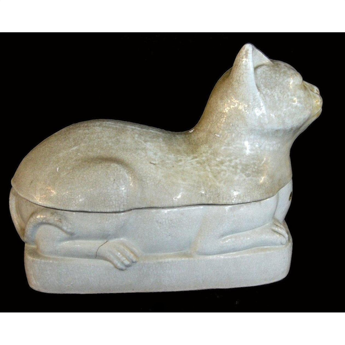 White porcelain cat figurine, glossy finish, reclining in profile against a black background, side view.