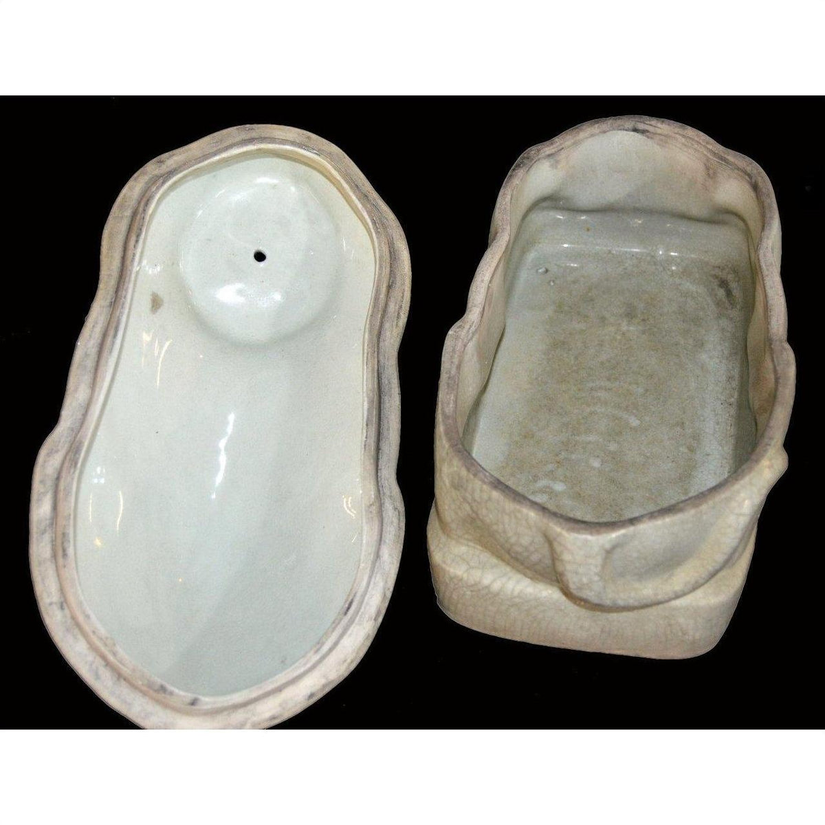 White porcelain cat figurine against black background.