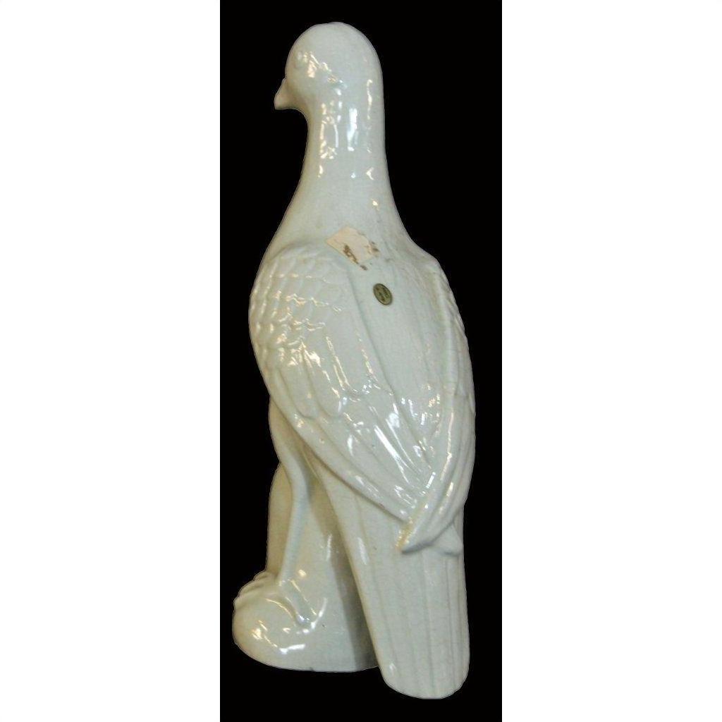 White porcelain dove with textured wings on a bold black background.